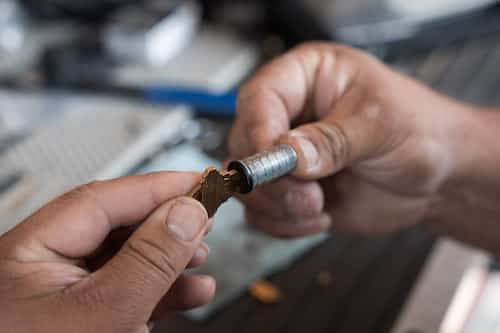 Noble locksmith technician testing a key in a lock cylinder they rekeyed